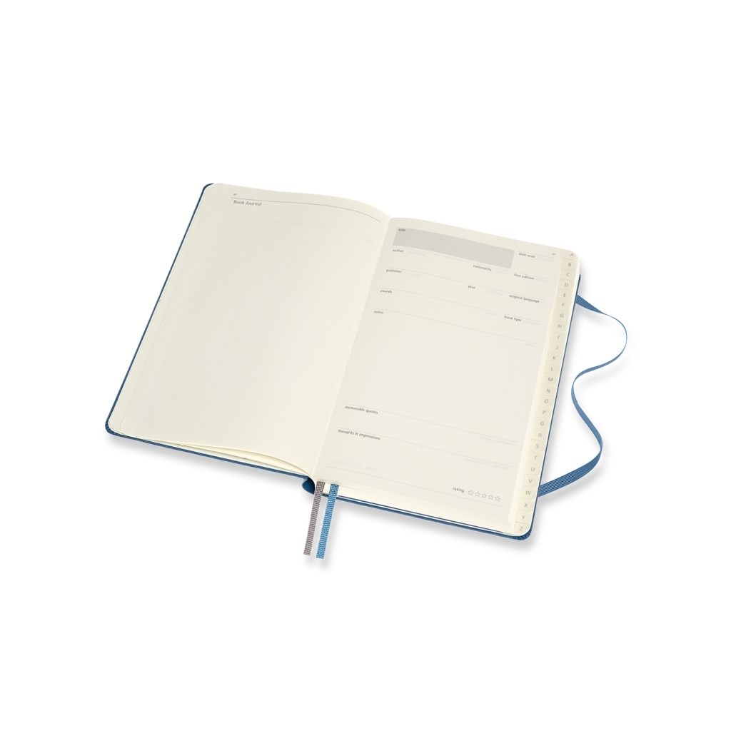 Atverstas mėlynas Moleskine Book Journal su knygos duomenų forma, vertinimo žvaigždutėmis, A–Z skirtukais ir dviem žymekliais